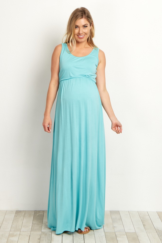 A basic sleeveless maternity maxi dress. Rounded neckline. Cinched under bust.