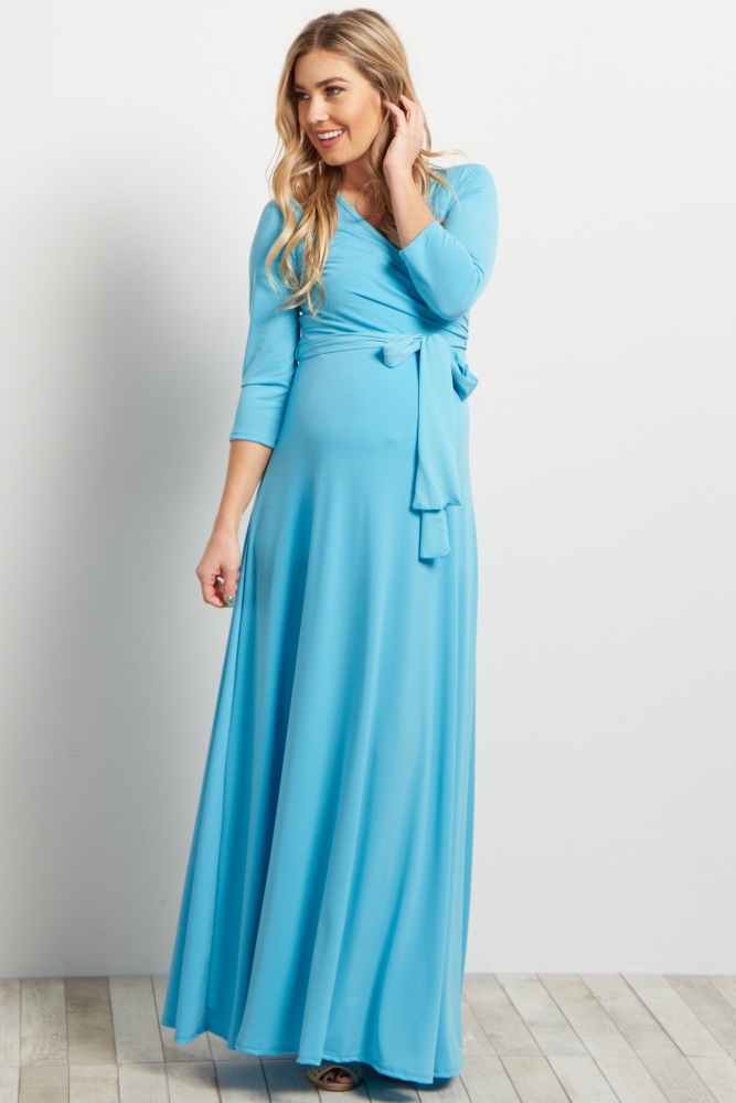 A solid maxi dress. Draped v-neckline. Cinched under bust. Sash tie. 3/4 sleeves.