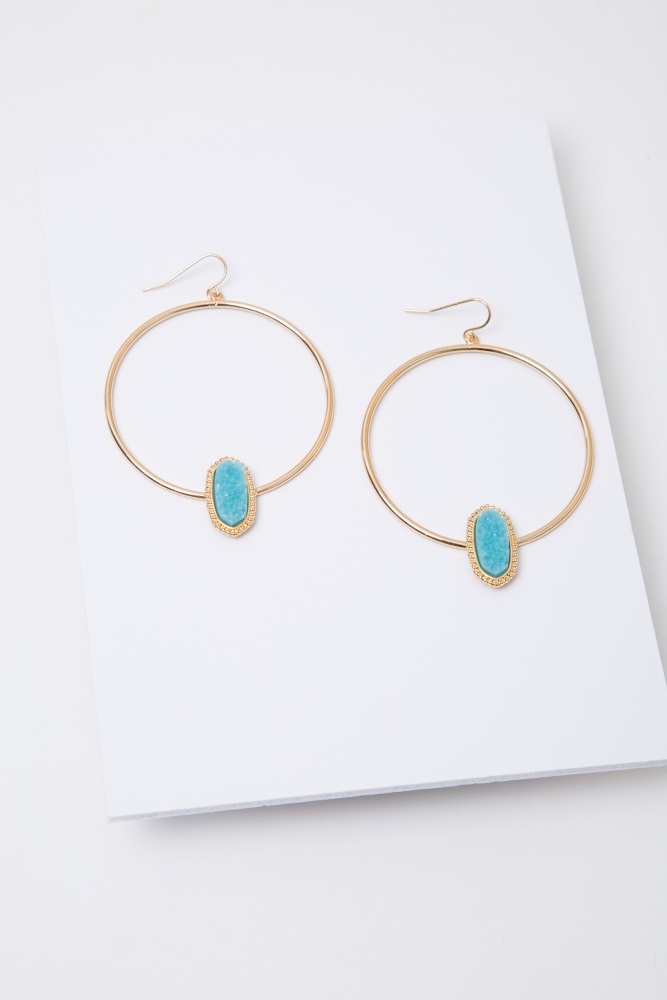 Gold hoop earrings with a faux geode accent and a fish hook back.