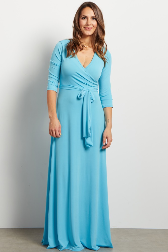 A solid maxi dress. Draped v-neckline. Cinched under bust. Sash tie. 3/4 sleeves.